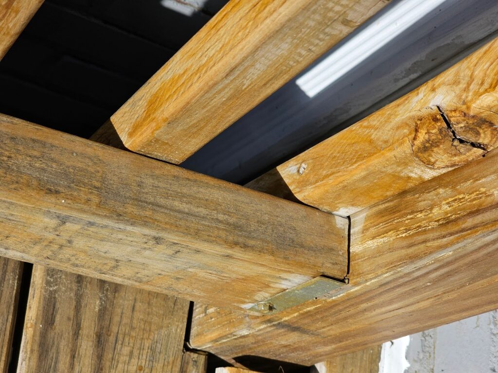 Close-up of metal connector clips in deck framing