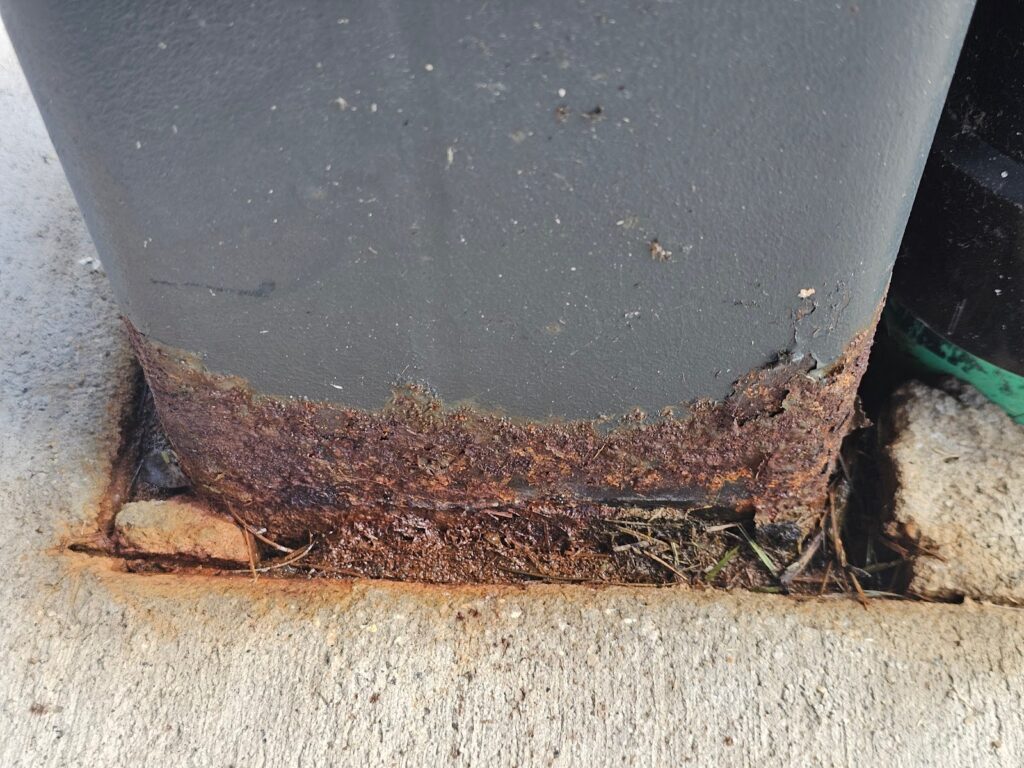 Close-up of rusting steel on outdoor post base