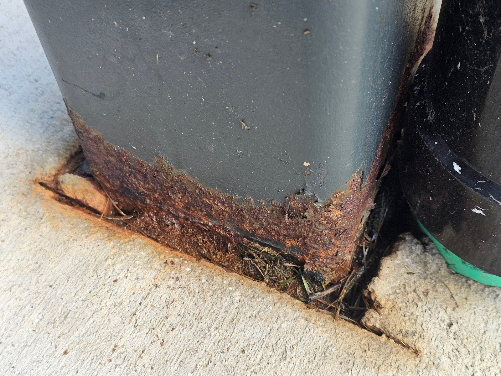 Rusting steel post bases causing structural damage