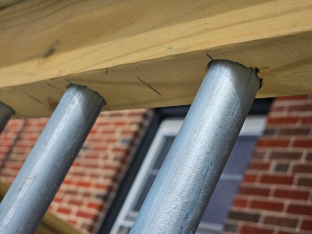 Deck railing design featuring electrical conduit balusters