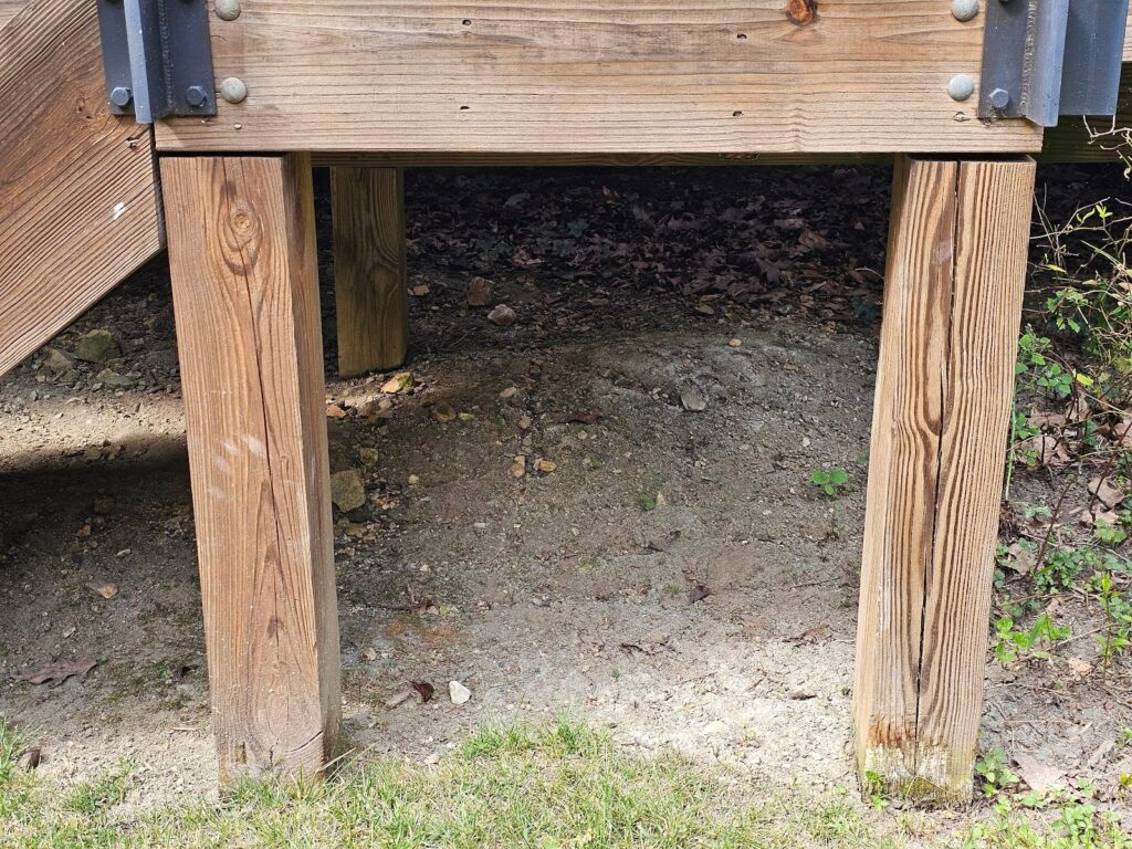 Metal handrail alignment issue on an older wooden deck