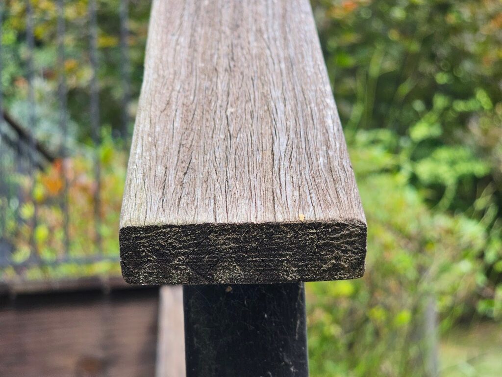 Metal handrail installed on a wood deck for added safety