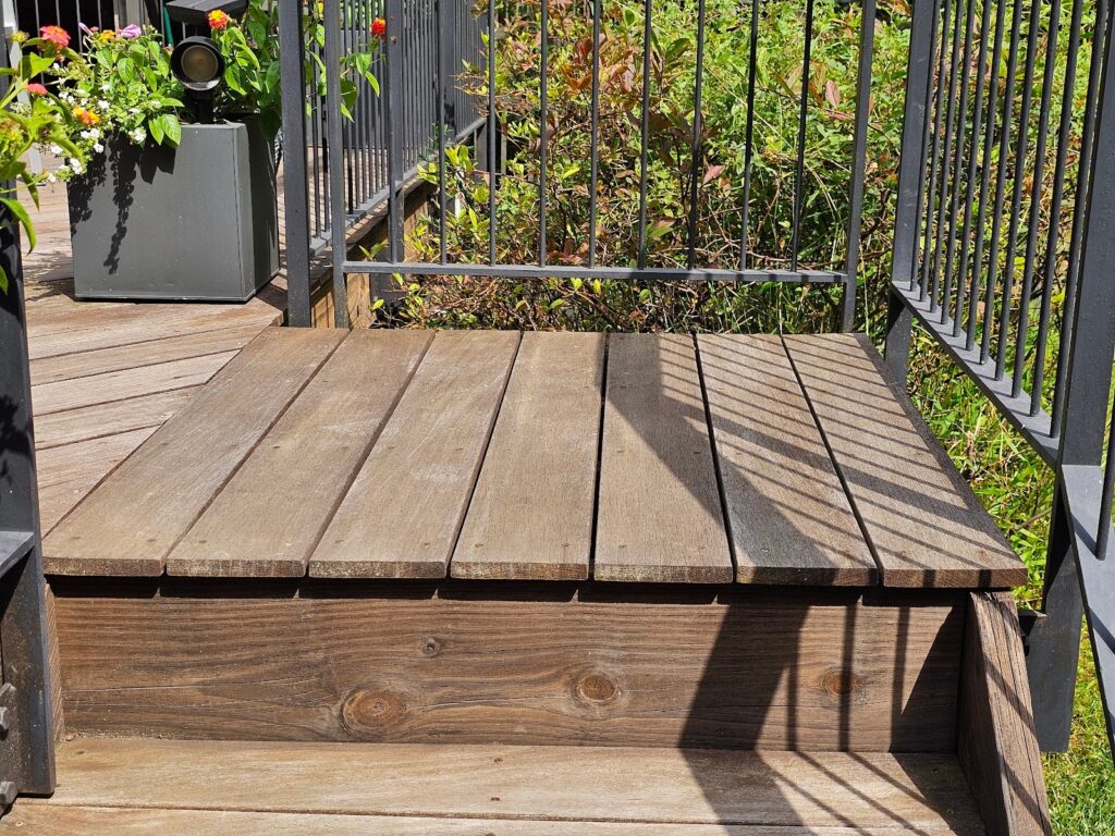 Rust spots forming on a metal handrail on an exterior deck