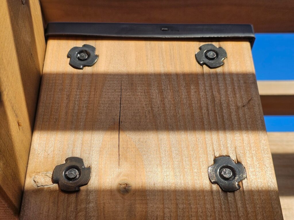 pattern of four bolts is securing the vertical post