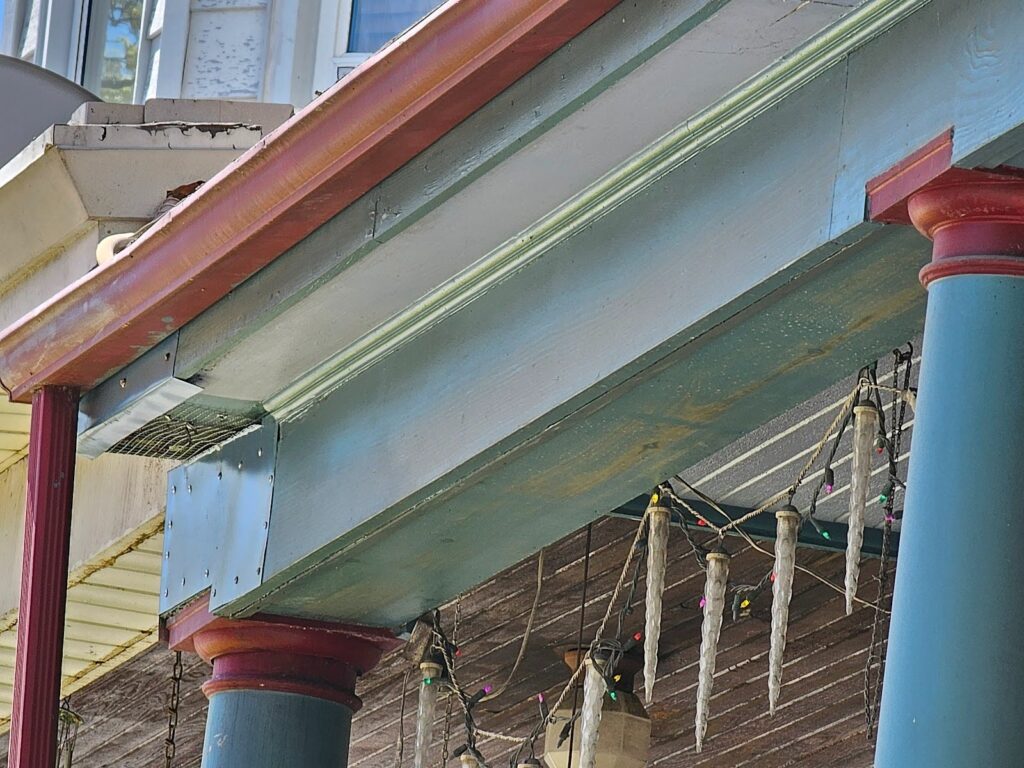 Close-up of porch soffit panels and fascia board detailing