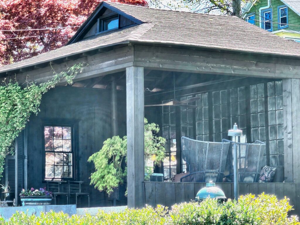 Residential patio with a roof-covered seating area and outdoor furnishings