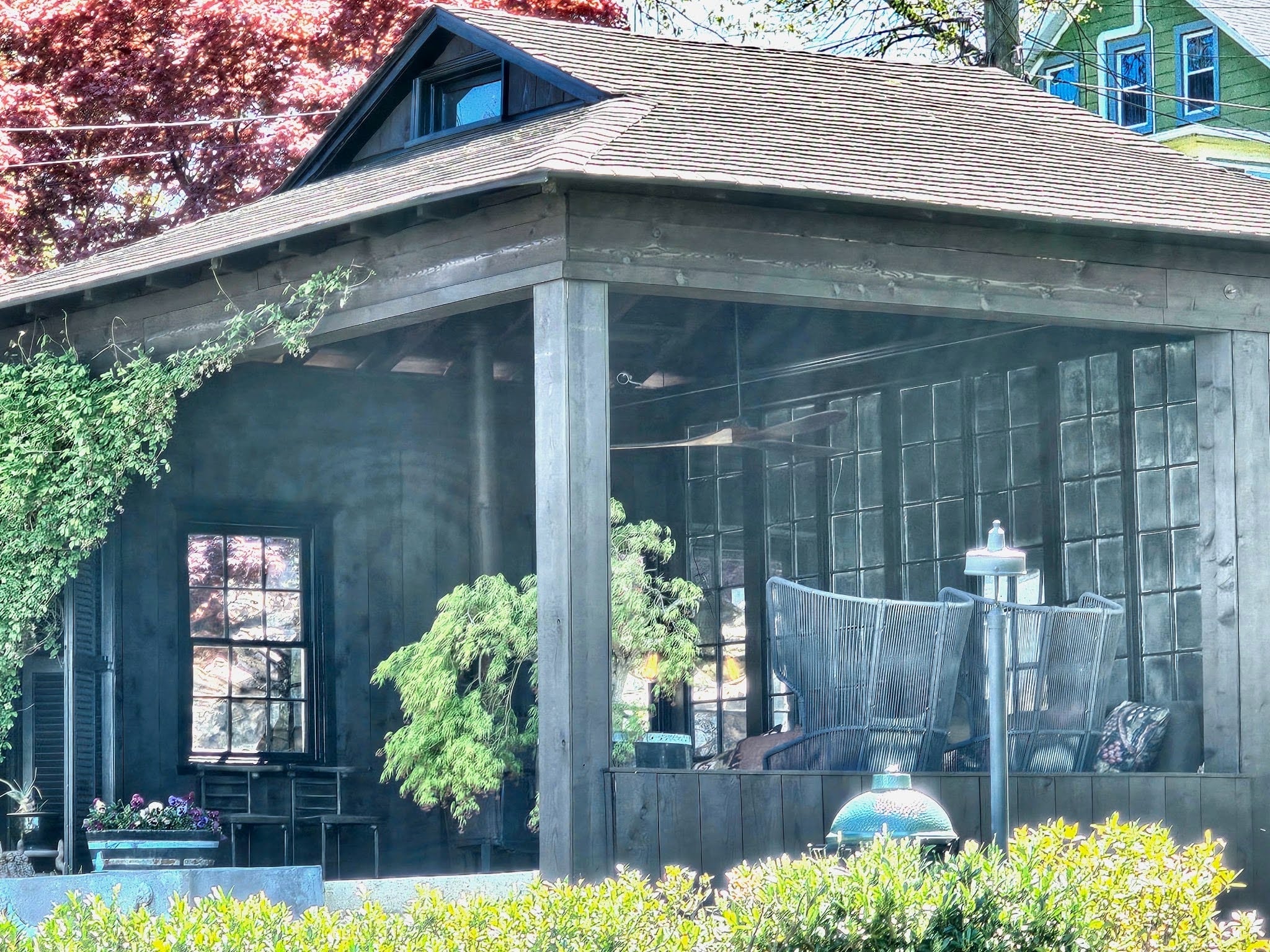 Residential patio with a roof-covered seating area and outdoor furnishings