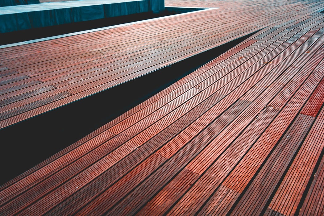 Deck Repair, Resurfacing or Replacement: Which Do You Need? 1 Grooved deck boards on a stepped deck, weathered to uneven tones
