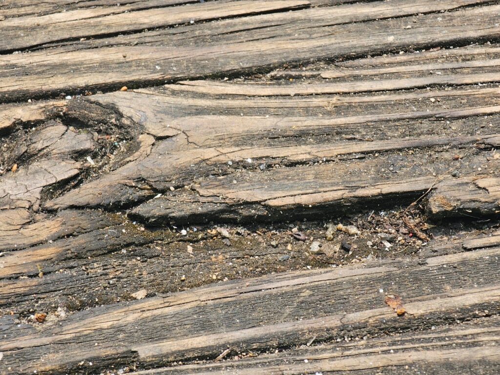 Wood deck showing signs of weathering and surface damage